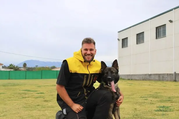 Manuel Jesús Melero Vera, instructor canino de K9 Málaga, con un pastor belga